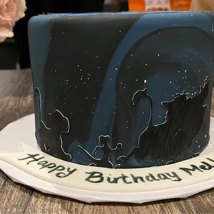 Silhouette of Lion King characters on the side of the cake
