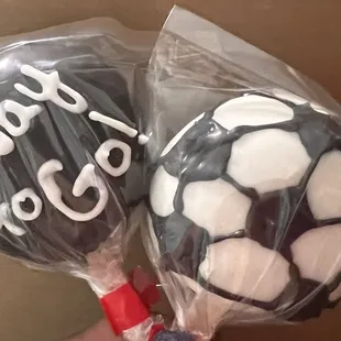 a hand holding a soccer ball