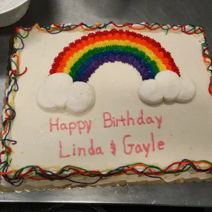 a rainbow and clouds on a sheet cake