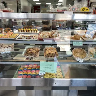 a variety of pastries in a display case