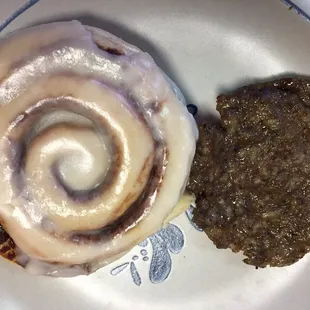 Cinnamon roll with fresh sausage.