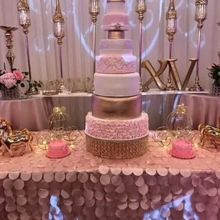 Gorgeous seven tier quinceñera cake  with two miniature smash cakes in each side