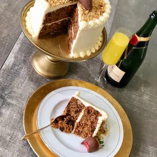 a slice of cake and a bottle of champagne
