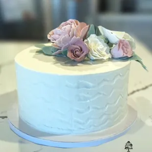 a white cake with flowers on top