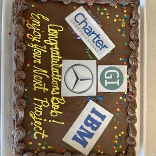 a chocolate cake with chocolate frosting and various stickers