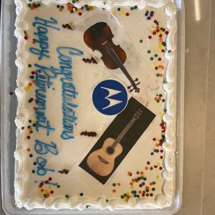 a sheet cake with a violin and a happy birthday message
