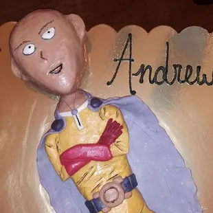 3D, rice krispy and modeling chocolate, coated in chocolate ganache underneath.