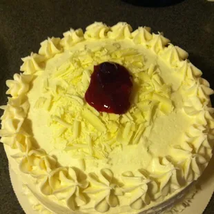 white cake, cranberry sauce filling with white chocolate frosting.