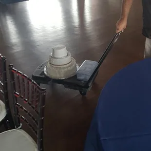 a man pulling a cart with a cake