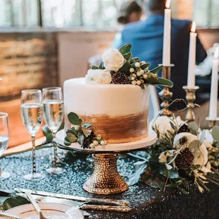 a cake on a table with candles and flowers