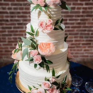 a wedding cake with pink flowers
