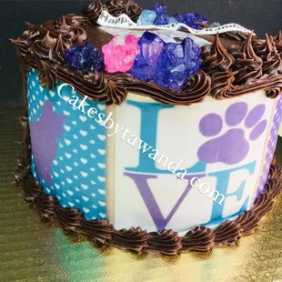 a cake decorated with chocolate icing and a paw print