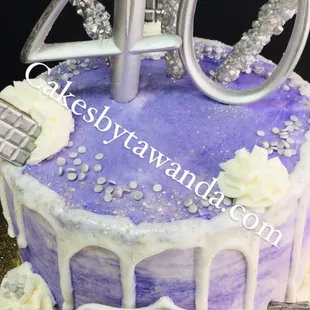 a purple cake with white icing