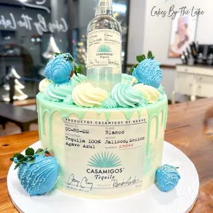 a bottle of vodka on top of a cake