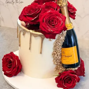 a bottle of champagne and roses