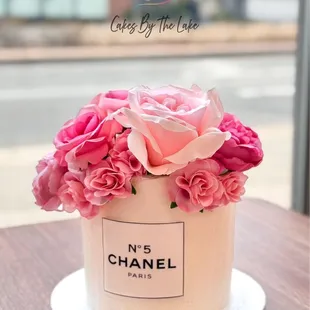 a chanel cake with pink flowers