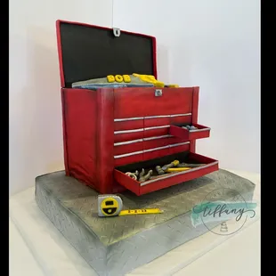 Custom tool box. 12x18 carrot cake- buttercream and fondant.  Tool box-5 layers- white almond wedding. All tools hand sculpted/painted.