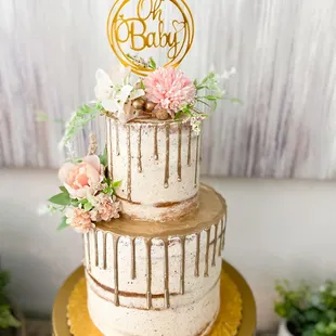 a three tiered cake with flowers on top