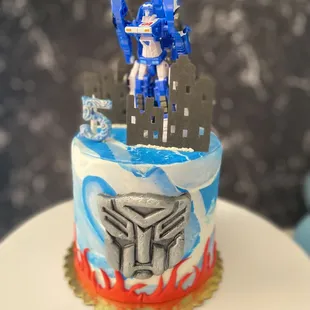 a blue and white cake with a robot on top
