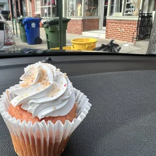 a cupcake on the dashboard of a car