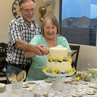 a man and woman cutting a cake