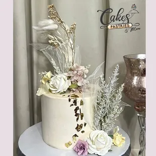 a white cake with flowers