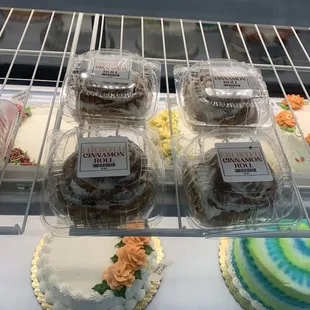 a variety of cakes in a display case