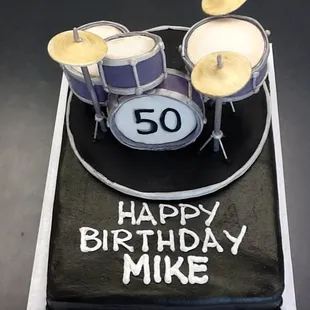 a birthday cake with a drum set