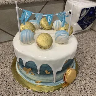a cake decorated with blue and gold decorations
