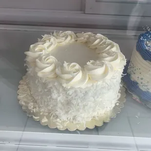 two cakes in a display case