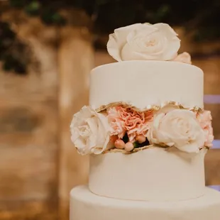 a wedding cake with flowers on top