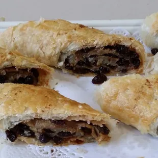 A Caribbean pastry with a blend of cinnamon spices, sugar and raisins rolled up in a flaky pastry dough baked and cut to the desired size.