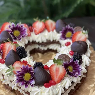 a heart shaped cake with strawberries and chocolate