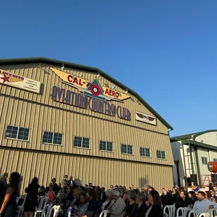Ceremony set up outside of hangar. Hangar opened after ceremony for cocktail hour and dinner. Cool grand reveal!
