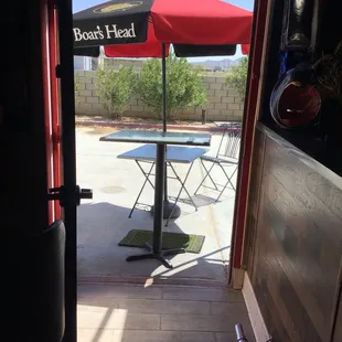 a patio with a table and umbrella