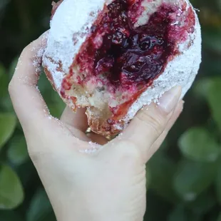 a hand holding a pastry