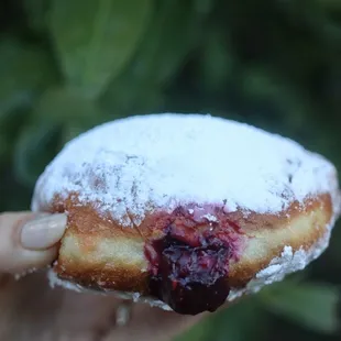 a hand holding a pastry