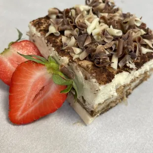 a piece of cake and a strawberry