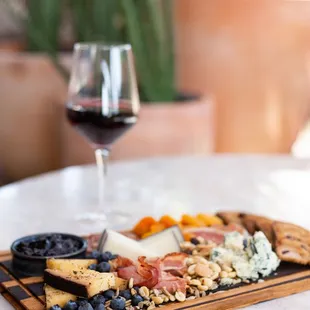 Artisan Salumi &amp; Cheese board: house made foccacia, marinated olives, marcona
almonds, dried apricots, cornicon