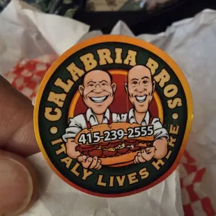 two men holding a hot dog