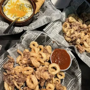 a plate of fried squids and a bowl of dipping sauce