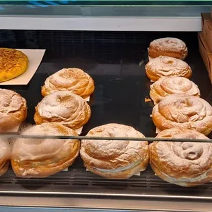 a variety of pastries in a display case