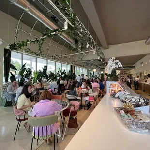 people sitting at tables in a restaurant