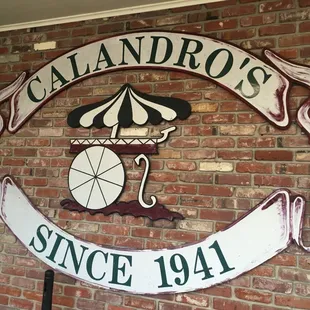 a sign on a brick wall