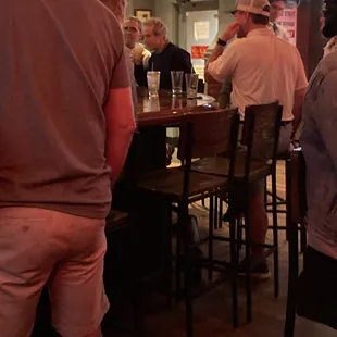 Two empty barstools "saved" by the bartender for over an hour and a half while we stood unable to get service.