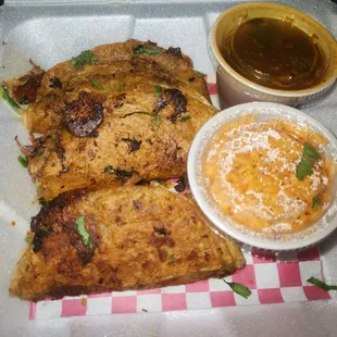 birria tacos, dipping sauce and a cup of rice