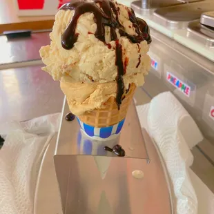Waffle cone with chocolate drizzle.