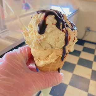 Waffle cone with chocolate drizzle.