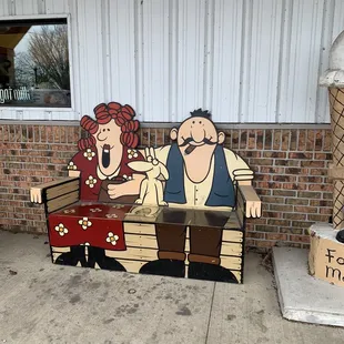 two people sitting on a bench