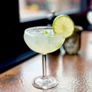 a margarita with a lime slice on the rim